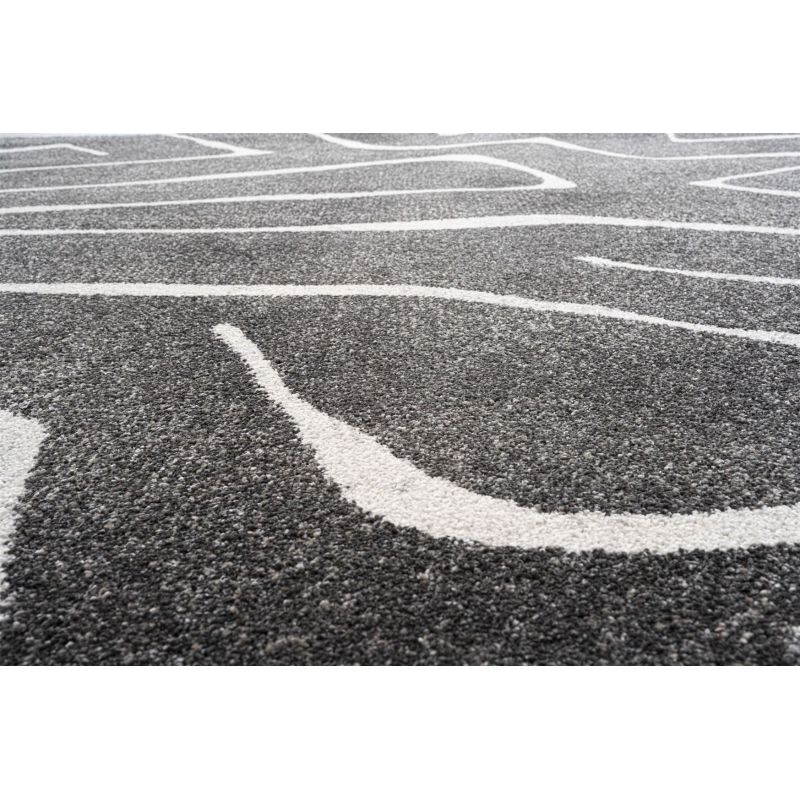 Tapis de salon polyester haut de gamme Magena design motifs blancs sur fond noir resistant entretien facile
