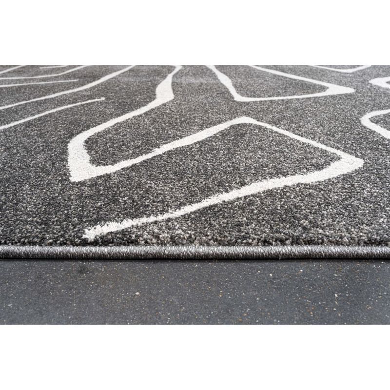 Tapis de salon polyester haut de gamme Magena design motifs blancs sur fond noir chambre