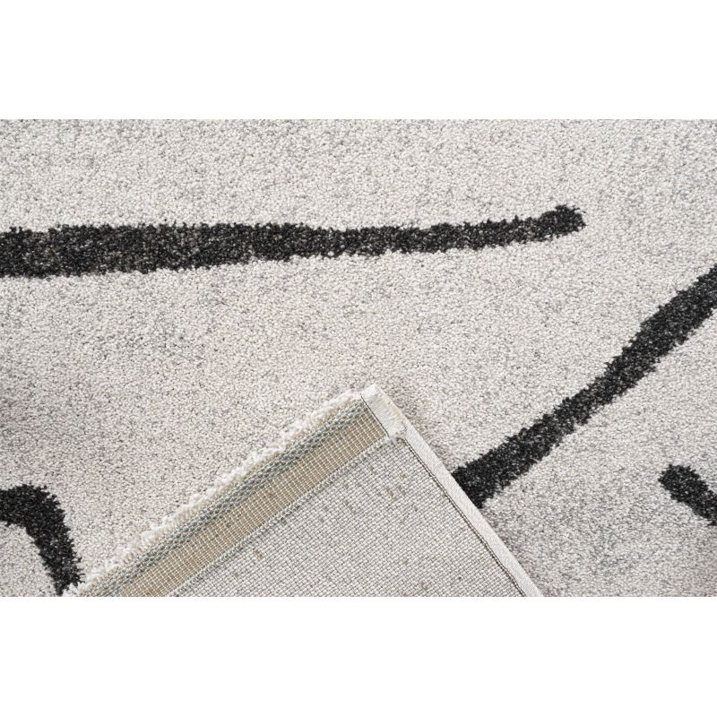 Tapis de salon polyester haut de gamme Magena design motifs noirs sur fond blanc ambiance classique