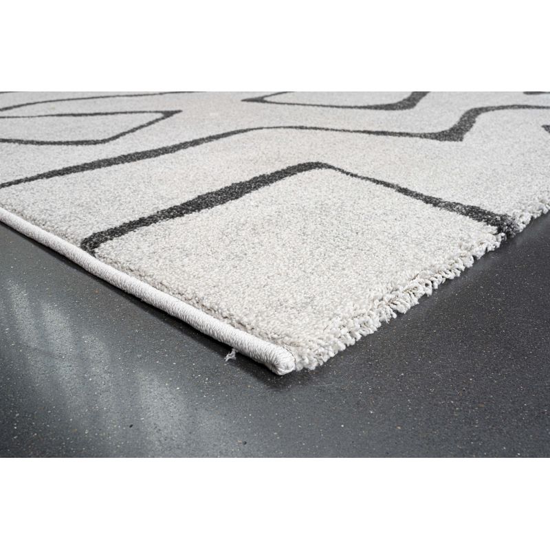 Tapis de salon polyester haut de gamme Magena design motifs noirs sur fond blanc décoration intérieure