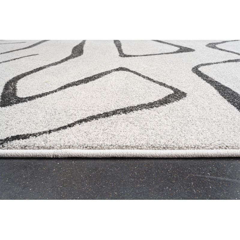 Tapis de salon polyester haut de gamme Magena design motifs noirs sur fond blanc séjour et salle à manger