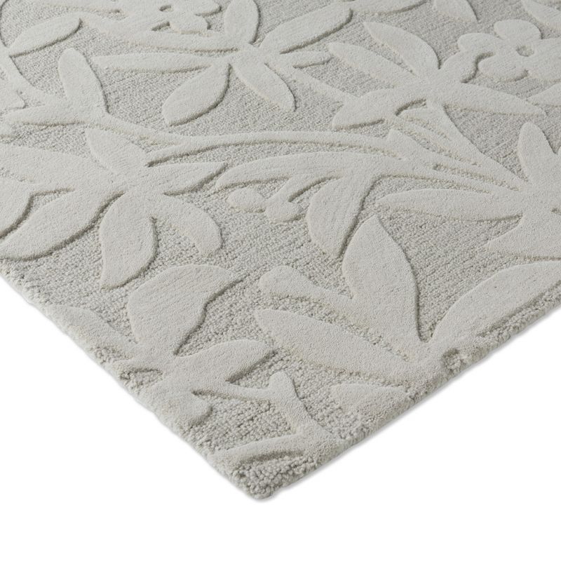 Tapis haut de gamme en laine motif végétal gris détail finitions