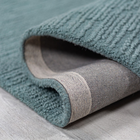 Tapis en laine bouclé bleu canard Harris replié